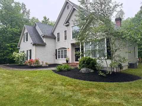 Foundation plantings and a mulch bed across the front of a house